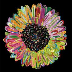 an image of a colorful flower made out of many different colored beads on a black background