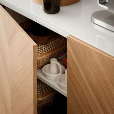 an open drawer in a kitchen next to a counter