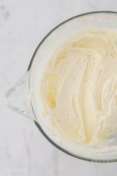 a blender filled with cream sitting on top of a counter