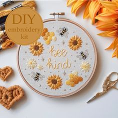 the embroidery kit has sunflowers and bees on it, along with other items