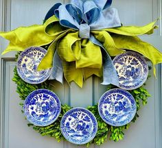 a wreath with blue and white dishes on it