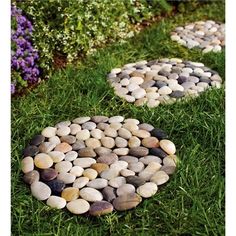 three stepping stones in the grass near flowers