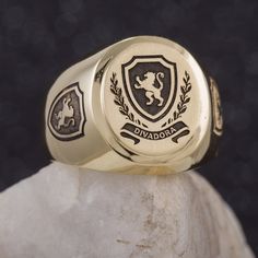 "This signet ring is crafted from 14K solid yelow gold and has a substantial feel to it with a designer quality finish. We can engrave your family crest on the top and sides of the ring and use our unique hand-crafted black finish to add contrast. We can also help you design a unique family crest using your choice of shield, symbols and text for an additional fee (please contact us for design pricing). ITEM DETAILS Item# SRGC006-FC Metal: 14K Solid Gold ITEM DIMENSIONS Width Widest Point: 18.23m Luxury Oval Engraved Ring Stamped 14k, Luxury 14k Stamped Oval Engraved Ring, Luxury Oval Engraved 14k Ring, Luxury 14k Engraved Oval Ring, Luxury Oval Engraved Ring, Luxury Engraved Ring With Polished Finish For Commemoration, Luxury Engraved Ring For Commemoration With Polished Finish, Luxury Oval 14k Stamped Signet Ring, Luxury Oval Engraved Ring With Engraving Option