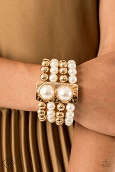 Held in place with a hammered gold frame dotted with two oversized white pearls, strands of classic gold beads and white pearls are threaded along stretchy bands that wrap around the wrist in a glamorously layered look. Sold as one individual bracelet. P9ST-GDXX-037VL RELEASED 4 OCT 20 Luxury Classic Pearl Bangle Bracelet, Luxury Statement Pearl Bracelet For Women, Luxury Statement Pearl Bracelets, Luxury High Luster Pearl Bracelet, Luxury Pearl Bangle Bracelets, Luxury Pearl Bracelet With High Luster, Luxury Handmade Pearl Bangle Bracelet, Luxury Gold Pearl Bracelet With High Luster, Luxury Statement Pearl Bangle Bracelet