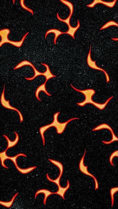 an orange and black fire pattern on a black surface with some red flames in the background