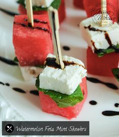 watermelon skewers with marshmallows and mint on a white plate