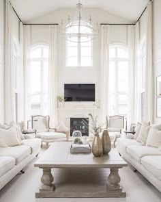 a living room filled with furniture and a fire place in front of a tv mounted on a wall