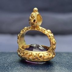 An amazing Victorian era fob seal, set with a large, oval amethyst to the base, mounted in a decorative engraved setting, crafted in 15ct yellow gold. An elegant item which would once have likely hung from a watch chain. A fine and heavy piece of antique jewellery.Circa 1850.Unmarked, tested as 15ct gold.The fob measures approximately 32 x 27mm.The seal face measures 19.7 x 15.3mm.The approximate weight is 17.2 grams.CONDITION: In overall very good antique condition, with some wear commensurate Elegant Gold Amethyst Cabochon Ring, Luxury Gold Oval Amethyst Ring, Luxury Gold Amethyst Ring Gift, Victorian Gold Oval Amethyst Ring, Gold Amethyst Cabochon Ring For Wedding, Gold Oval Amethyst Ring For Gift, Victorian Gold Amethyst Ring In 14k Gold, Antique Gold 14k Gold Amethyst Ring, Gold Victorian Amethyst Ring In 14k Gold