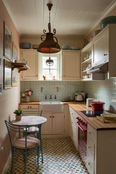 a small kitchen with a table and chairs next to the sink in front of a window