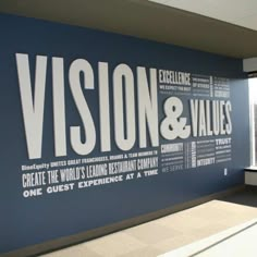 a room with a large sign that says vision and value on the wall next to a window