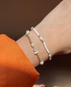 This beautiful bracelet is made of natural freshwater pearls and tiny white and gold beads that glow like tiny droplets of moonlight. Slide on this pearl bracelet for an added pop to your arm party! DETAILS ▴ Material: 14k Gold-Filled, Freshwater Pearls, Natural Gemstones ▴ Length: 16cm + 3cm extender ▴ Ready to ship once order is placed OUR PROMISE ▴ Fair prices: Quality 14k gold-filled jewelry at an attainable price-point. Everything is done in-house. ▴ Honest quality: Quality matters. We only White Delicate Beaded Bracelet, Delicate White Round Beaded Bracelets, Delicate White Hand-strung Bracelets, Delicate White Beaded Bracelet, Dainty Pearl Beaded Bracelets With Tiny Beads, Dainty Pearl Beaded Bracelet With Tiny Beads, Delicate White Beaded Bracelets, Dainty White Hand-strung Bracelet, Everyday White Pearl Beaded Bracelets