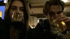 two people are drinking wine in a restaurant