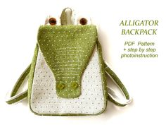 a green and white bag with two eyes on the front, one in the shape of a frog