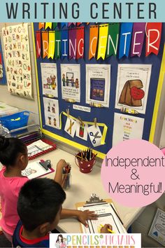 two children writing in front of a bulletin board with the words writing center written on it