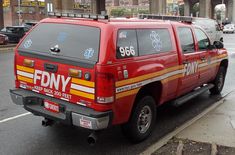 an fdny truck parked on the side of the road in front of a building