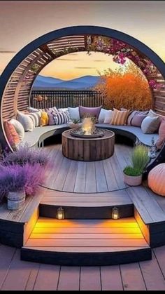 an outdoor fire pit surrounded by wooden decking and seating area with lots of pillows