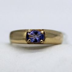 ⚓14K Gold  Sideways Oval Tanzanite Ring (Size 6.5) Solid 14K gold, stamped 14K. Not filled or plated. In excellent condition! We sell the highest quality vintage and pre-owned items. Free domestic shipping always! On its way to you in 1 business day.  30 day return policy!  ⚓The Details Size 6.5 1 Tanzanite approximately 0.288 ct wt 5.21 mm band width at crown of ring 3.31 mm band width at bottom 4.1 grams ⚓Who We Are  We are a small, family-owned business in Plymouth, MA. Located in the heart of Main Street, Main Street Jewelry Co.'s mission is to find one-of-a-kind, unique pieces. Vintage, antiques, and rare finds are our specialty, of course other than our brand new Italian silver chains with a price that can't be beat. We thank you for supporting small businesses everywhere and checkin Classic Gold Amethyst Birthstone Ring, Classic Gold Amethyst Solitaire Ring, Timeless Gold Amethyst Ring For Anniversary, Vintage Gold Amethyst Birthstone Ring, Classic Domed Sapphire Ring, Vintage Oval Sapphire Birthstone Ring, Vintage Oval Sapphire Ring As Birthstone, Classic Domed Sapphire Ring Gift, Timeless Gold Oval Amethyst Ring