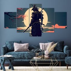 a living room with blue couches and three paintings on the wall in front of it