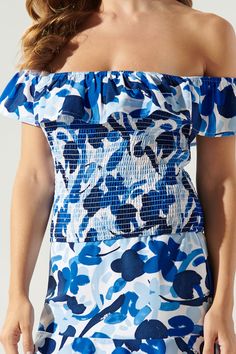 Cool like the sea, this blue abstract floral print embodies the perfect top for a warm day out to brunch. It features an off the shoulder design with a ruffle detail that sweeps from shoulder to shoulder. The bodice is fully smocked to create a flattering fit that ends right at the hips. Wear it with bottoms of your choice or complete the coord set with the matching skirt.- Smocked- Off the shoulder- Ruffle detail- Color: White BlueSize + Fit - Model is 5'9" and wearing size XS- Measurements tak Summer Smocked Top With Elastic Neckline For Beach, Blue Top With Smocked Back For Vacation, Blue Smocked Top For Summer Brunch, Blue Smocked Top For Vacation, Blue Smocked Bodice Top For Vacation, Blue Smocked Top With Smocked Back For Vacation, Summer Floral Print Pool Tops, Blue Ruched Smocked Top For Beach, Blue Ruched Smocked Top For The Beach