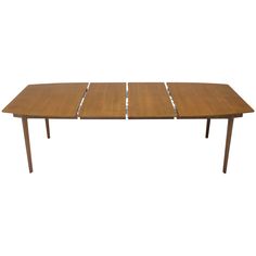 a wooden table with four leaves on it