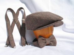 Wedding flat cap, bow tie and suspenders set. Perfect birthday photo prop or ring bearer hat set. More than just a prop, this cap may become the hat your toddler wears every where. The fabric in the first photo is NO Longer available.  You may purchase a set that matches any of the hats in this listingAll caps are handmade, so each hat is custom created to the size you need. Each hat is custom made to your size. To find out what size works best for you, start with a soft measuring tape or piece Adjustable Brown Hats For Birthday, Adjustable Brown Mini Hats As Gifts, Adjustable Brown Mini Hat As Gift, Adjustable Brown Mini Hats As Gift, Vintage Adjustable Hats For Birthday, Classic Adjustable Mini Cap Hat, Adjustable Brown Hat For Gift, Ring Bearer Hat, One Year Old Birthday