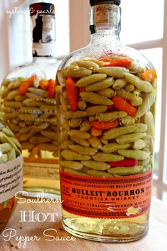 a bottle filled with green beans and carrots