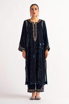 Deep blue velvet kurta, featuring longline hem in straight silhouette, highlighted with placement contrast hand embroidery. Paired with a straight pant.
Components: 2
Pattern: Placement Hand Embroidery
Type Of Work: Sequin, Zari, Flower
Neckline: Notched Round Neck
Sleeve Type: Full Sleeves
Fabric: Velvet
Color: Blue
Other Details: 
Floral hand embroidery on the back of the kurta
Placement floral hand embroidered pant
Occasion: Puja,Mehendi and Haldi - Aza Fashions Velvet Suit Design, Velvet Kurta, Ramadan 2024, Pant For Women, Recipes Indian, Velvet Suit, Embroidered Pants, Suit Design, Embroidered Neckline