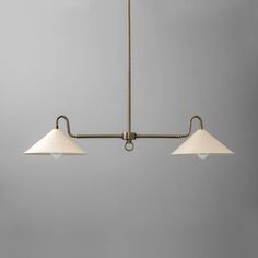 three light chandelier with two white shades on the bottom and one beige shade on the top