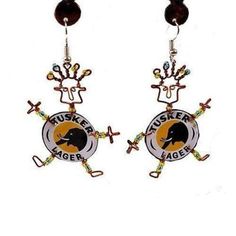 a pair of earrings with an eagle and crossbones on the bottom of it