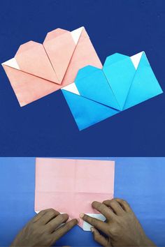 origami hearts are folded in pink and blue paper to make an origami heart