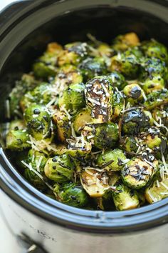 a pot filled with cooked brussel sprouts and parmesan cheese