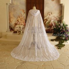 a wedding dress on display in front of a painting