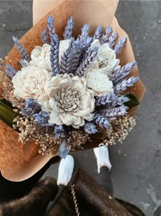 a bouquet of flowers sitting on top of a brown bag