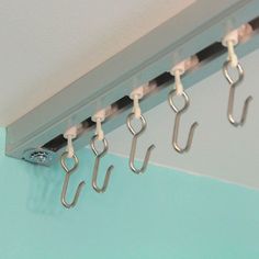 several hooks are hanging on the side of a wall