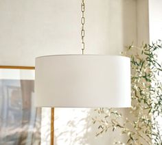 a white lamp hanging from a ceiling in a living room