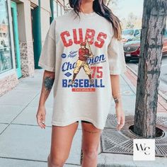 Cubs T-shirt Streetwear Graphic T-shirt For Baseball Season, Graphic Tee T-shirt For Fan Merchandise, Casual T-shirt With Front Print For Fans, Casual Short Sleeve Shirt For Baseball Season, College Fan Apparel T-shirt Short Sleeve, Casual Pre-shrunk T-shirt For Baseball Season, Short Sleeve Cotton Tops For Baseball Season, Casual Short Sleeve Fan Merchandise T-shirt, Short Sleeve Shirt With Text Print For Baseball Season