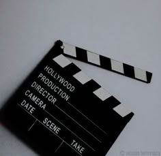 a black and white movie clapper with the words'hollywood production director'written on it