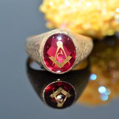 A gentleman's 10 karat yellow gold Masonic ring set with a 12 millimeter by 10 millimeter oval red spinel stone.  This ring is a size 10.5 Spinel Stone, Red Spinel, Rose Gold Morganite, Masonic Ring, Diamond Anniversary Rings, Diamond Anniversary, Size 10 Rings, Morganite, Estate Jewelry