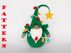 a crocheted christmas ornament with a green tree on it's back