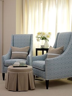 a living room with two chairs and a coffee table