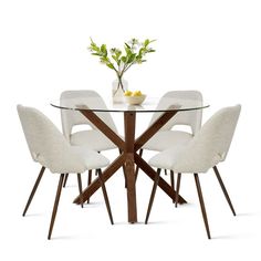 a glass table with four chairs around it and a vase filled with flowers on top