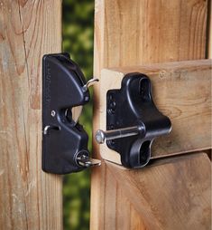 a pair of black latches are attached to a wooden door