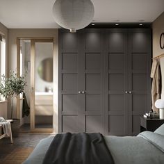 a bedroom with dark gray cabinets and white lights on the ceiling, along with a large bed