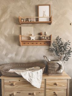 a baby's crib in the corner of a room with two shelves above it