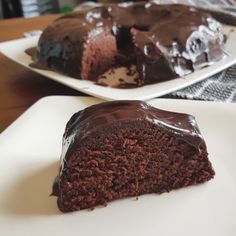 there is a piece of chocolate cake on the plate and one slice has been eaten