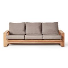 a wooden couch with four pillows on it's back and side, in front of a white background