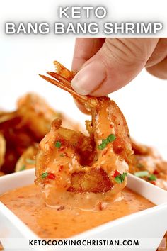 a person dipping some kind of food into a small white bowl with sauce on it