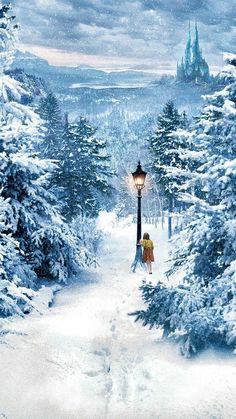 a person walking down a snow covered path in front of a light post and trees