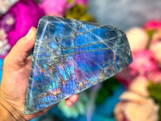 Experience the enchantment of Rainbow Labradorite—your talisman for protection! Each carefully polished stone reveals a dance of colors, from violet and neon blue to mesmerizing orange. Larger gems boast a spectrum of magical hues. Let this mystical crystal guard your aura and connect you with the ethereal. Need more captivating crystals? Follow us for a world of protective treasures! Marble Inspiration, White Labradorite, Crystal Aesthetic, Secrets Of The Universe, Cool Rocks, Labradorite Crystal, Purple Violet, Purple Labradorite