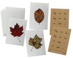 four cards with different designs on them and some type of leaf in the middle one